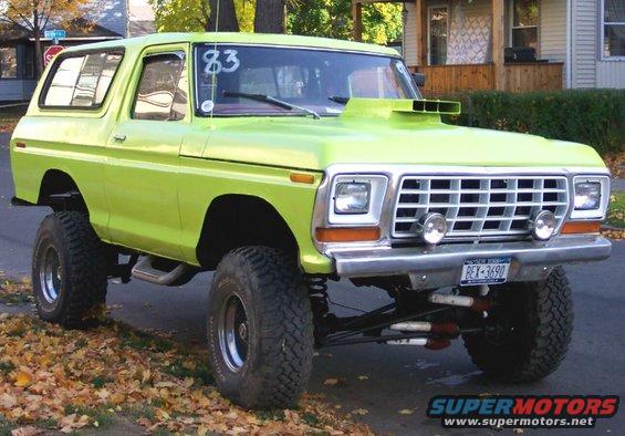 Lime green 1978 Ford Bronco with a hood scoop, large tires, and a lifted suspension
