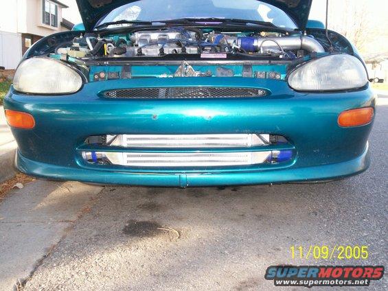 Teal 1994 Mazda MX-3 front view with hood open, showing engine and aftermarket intercooler