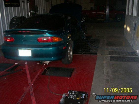 teal 1994 Mazda MX-3 on a dynamometer with hood up