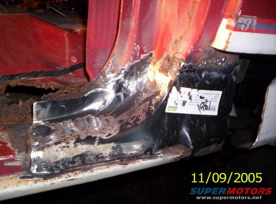 close-up of heavily rusted metal on a vehicle's frame, with a sticker showing '1981'