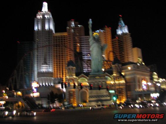 Las Vegas skyline at night with Statue of Liberty replica and buildings illuminated