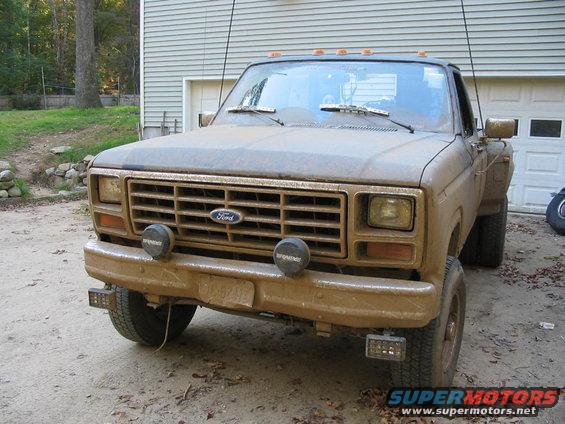 Mud-covered Ford truck, front view. Grille and headlights suggest an early 1980s model