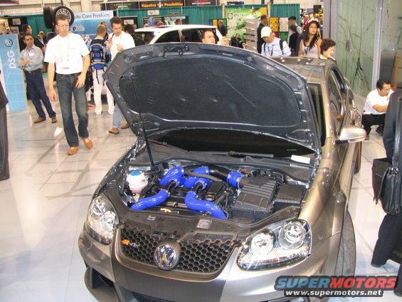 Gray Volkswagen Golf GTI with blue turbo pipes and exposed engine