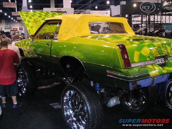 Green and yellow checkered convertible with lifted suspension and chrome rims