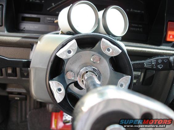 Steering column with two gauges mounted above, and a ratchet wrench attached to the steering shaft