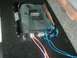 1992 Ford Crown Victoria - A car amplifier is shown with its wiring connected, installed in a carpeted area.