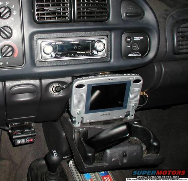 Dashboard of a vehicle with an aftermarket stereo, a portable GPS device mounted, and a trailer brake controller