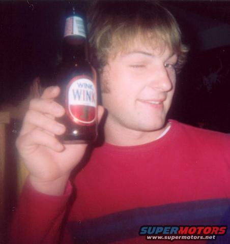 Man winks while holding a bottle of Wink soda