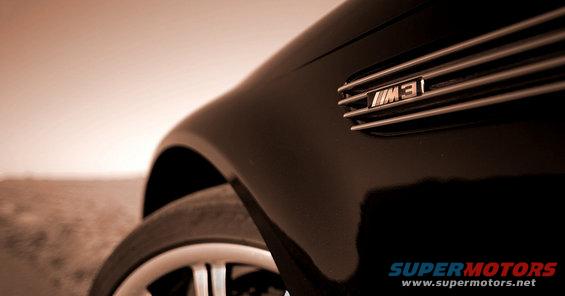 Black car fender with chrome M3 badge and horizontal grille