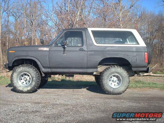 Lifted Ford Bronco with aftermarket wheels and tires, side view