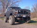 1986 Ford Bronco - This lifted Ford Bronco features a prominent grille and off-road tires, suggesting an earlier model year than claimed.