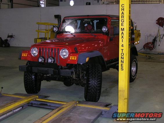 Red Jeep Wrangler TJ with snorkel and aftermarket lights