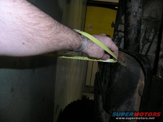 Measuring a vehicle part with a tape measure