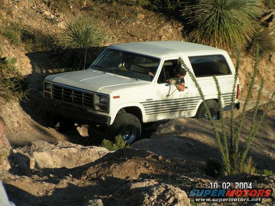 1983 Ford Bronco navigating rocky off-road terrain