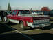 2002 Ford F-250 - This Dodge pickup truck features a prominent tall exhaust pipe and a two-tone red and silver paint scheme.