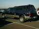 2002 Ford F-250 - This 2002 Ford F-250 Super Duty pickup truck is equipped with a blue camper shell and has 4x4 off-road badging.