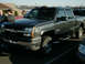2002 Ford F-250 - This dark gray pickup truck, seen from a 3/4 front angle, is likely a 2003 Chevrolet Silverado 2500HD, not the 2002 Ford F-250 listed in th…