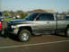 2002 Ford F-250 - Side view of a gray Dodge Ram pickup truck parked in a lot.