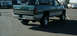 2002 Ford F-250 - This Dodge pickup truck, likely from the mid-1990s, is shown from the rear in a parking lot.