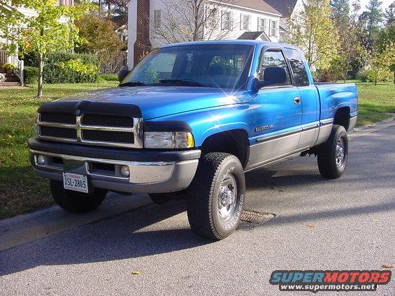 Blue Dodge Ram pickup truck parked on street, two-tone paint, chrome bumper and wheels