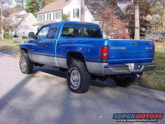 Blue Dodge Ram pickup truck with silver lower body, parked on a residential street