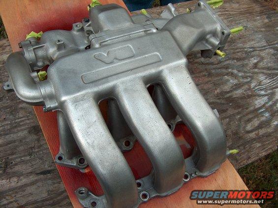 Aluminum intake manifold with V6 marking, taped for painting