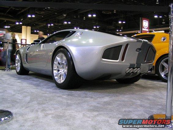 Silver concept car rear view with racing stripes and quad exhaust pipes