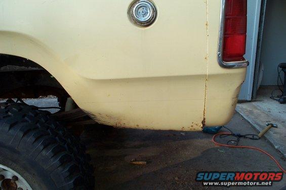1978 Dodge Power Ram rear quarter panel with rust near the bottom and a fuel filler cap