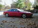 1994 Ford Probe - A red 1994 Ford Probe is parked in a driveway with fallen leaves on the ground.