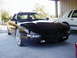 1994 Ford Probe - A black Ford Probe is parked under a carport next to a white sedan.