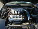 1994 Ford Probe - The engine bay of a car, a V6 engine with custom blue intake piping and a strut bar.
