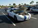 1994 Ford Probe - White 1994 Ford Probe with blue racing stripes, engine exposed, parked at a car show.