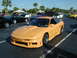 1994 Ford Probe - Customized 1994 Ford Probe at a car meet, surrounded by other vehicles under a clear sky.
