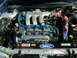 1994 Ford Probe - Engine bay of a silver car with a V6 DOHC engine and various aftermarket modifications visible.