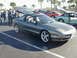 1994 Ford Probe - A gray 1994 Ford Probe GT is parked with its trunk and hood open, showing other vehicles in the background.
