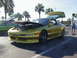 1994 Ford Probe - A yellow 1994 Ford Probe is parked with its hood and trunk open, alongside another car.