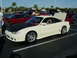 1994 Ford Probe - A modified coupe with a black hood and custom body kit is parked at an outdoor car show.