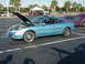 1994 Ford Probe - A blue coupe with its hood open is parked in a lot next to a purple car.