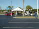 1994 Ford Probe - Two cars are displayed under a tent at an outdoor event, with people milling around.