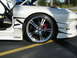 1994 Ford Probe - A white 1994 Ford Probe is shown from the front quarter angle, highlighting its custom wheels and racing decals.