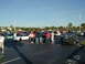 1994 Ford Probe - A gathering of cars and people in a parking lot under a clear blue sky.
