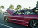 1994 Ford Probe - A red 1994 Ford Probe is shown with its hood and trunk open, parked outdoors with other vehicles visible.