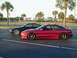1994 Ford Probe - Two Ford Probes, one red and one black, are parked in a lot with palm trees in the background.