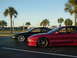 1994 Ford Probe - Two Ford Probes, one red and one black, are parked next to each other on a sunny day.
