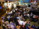 1994 Ford Probe - A busy restaurant scene with many patrons seated at tables, and a dark-colored car parked inside.