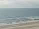 1994 Ford Probe - Ocean view from a beach with two people walking along the shore. Supermotors.net logo visible.