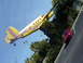 1994 Ford Probe - A red coupe is parked on asphalt next to a yellow airplane with colorful stripes and 'Island Charters' written on its side.