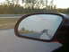 1994 Ford Probe - View of another car in the side mirror while driving on the highway.