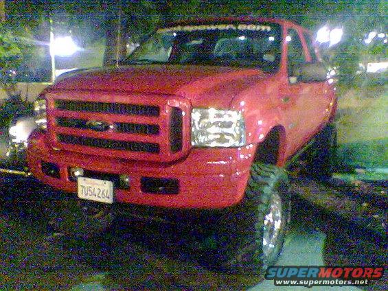 Red pickup truck front view with license plate 7U54264