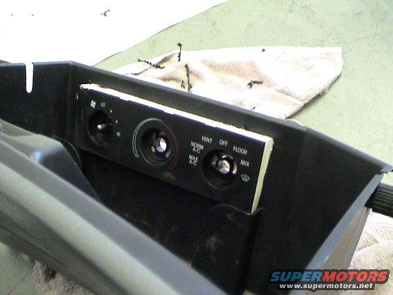 Center console climate controls with knobs for fan speed, temperature, and air direction